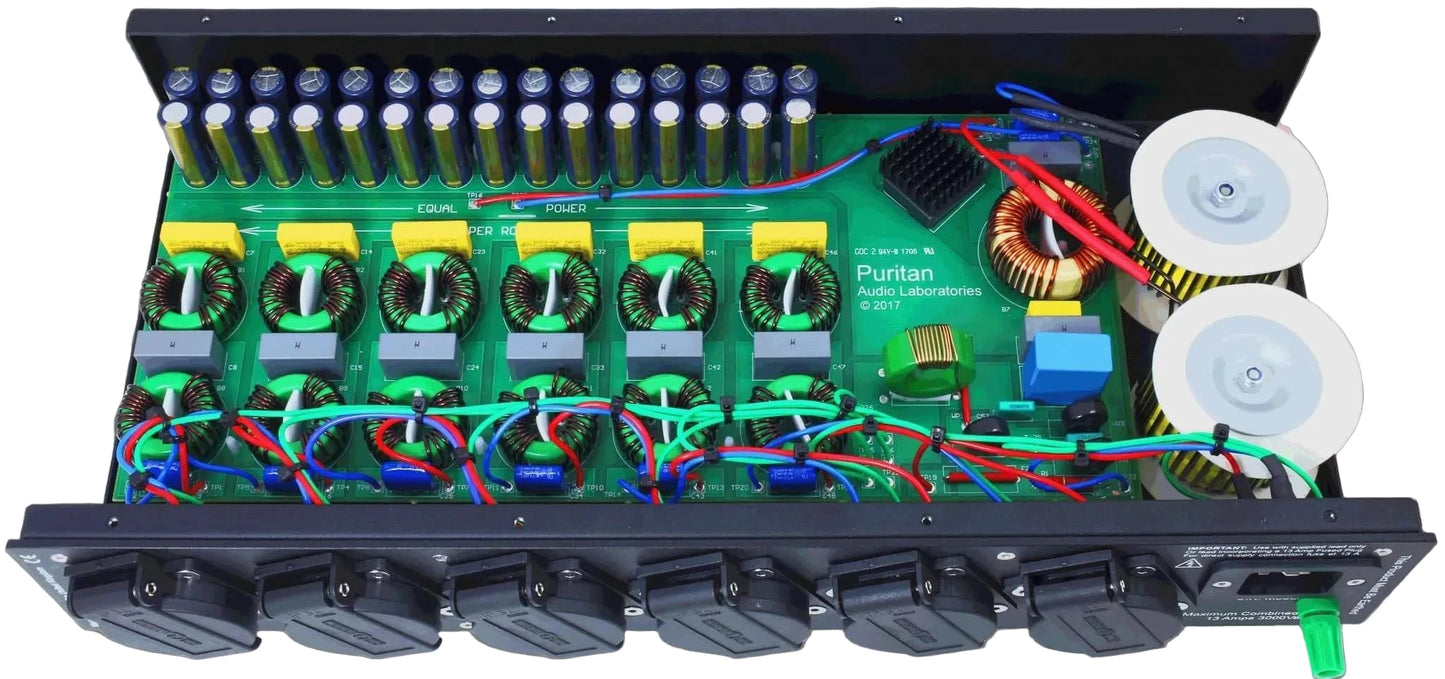 The image shows the internal components and design of the Puritan Audio PSM156 Studio Master Mains Purifier, including multiple outlets and electronic circuitry.